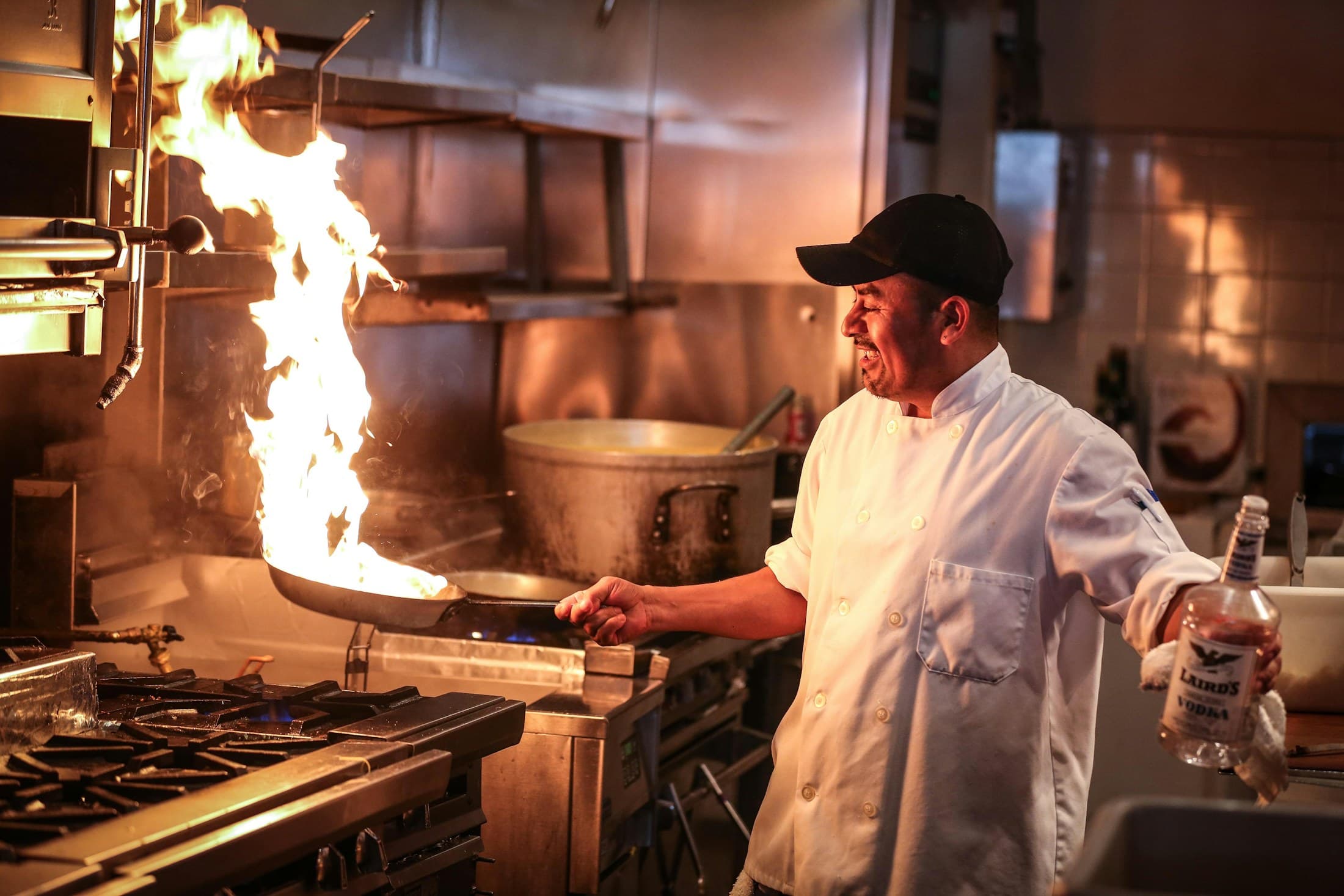A cook working over a tall flame in the La Rio kitchen.