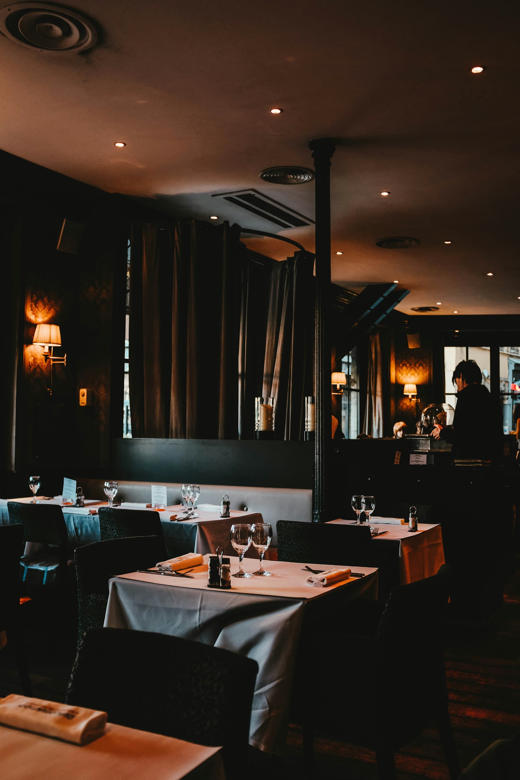 A quiet corner of the dining room lit by wall lamps.