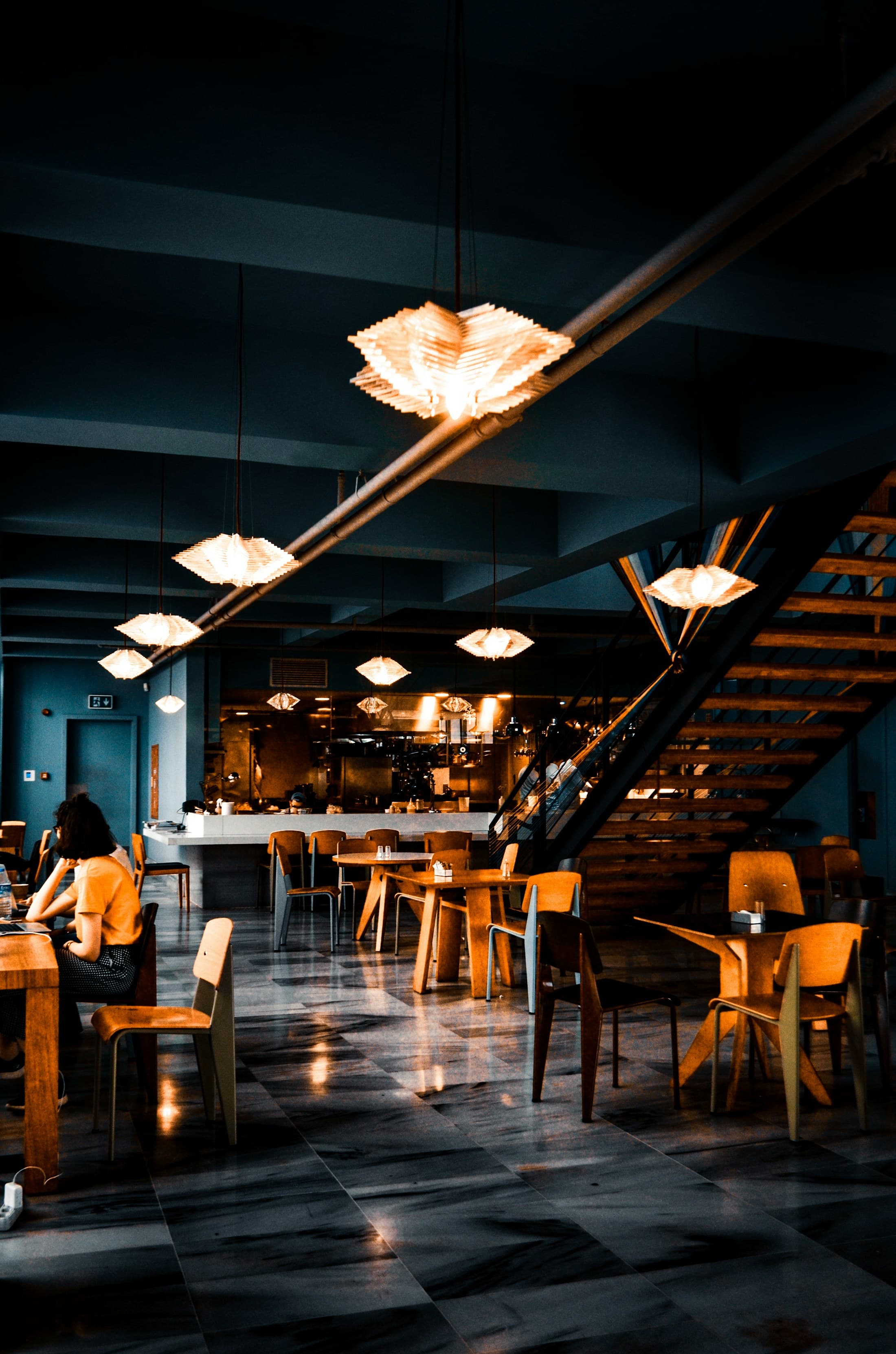 Pendant lamps hanging over the dining floor and the staircase.