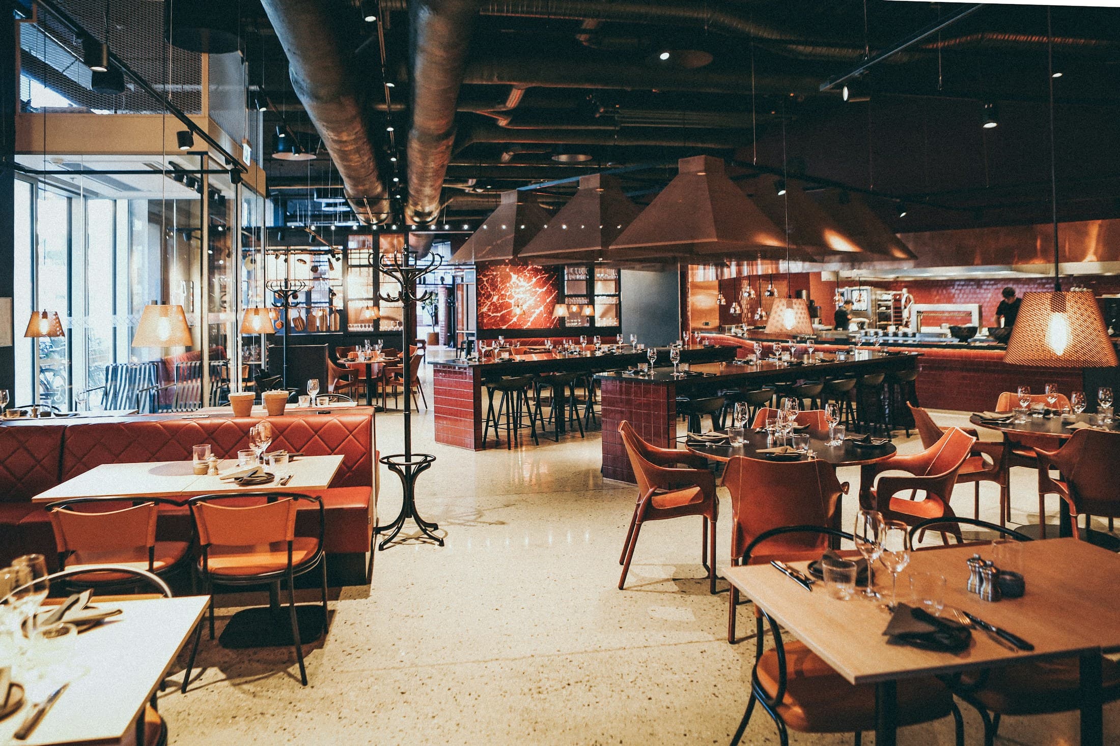 The open dining floor with the kitchen hood in the background.